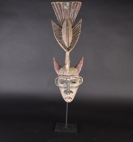 Lot 118 - A Guro mask, Ivory Coast, painted red and...
