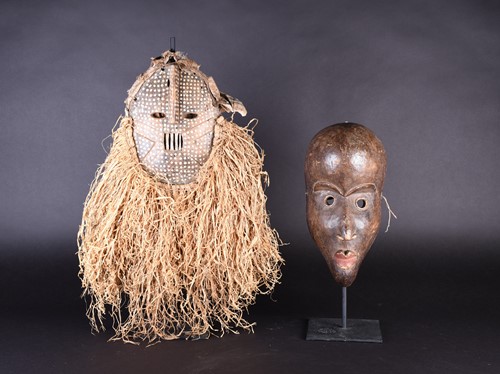 Lot 130 - Two West African masks, possibly Dan, Ivory...