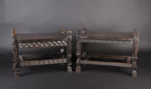 Lot 126 - A near pair of Rwandan carved wood stools,...