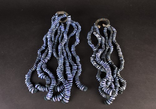 Lot 145 - Fourteen strings of African cowrie shells,...