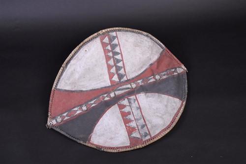 Lot 146 - A Maasai painted hide dance shield, Kenya, of...