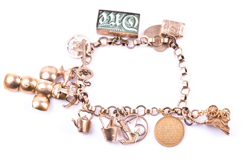 Lot 601 - A 9ct yellow gold charm bracelet, suspended...