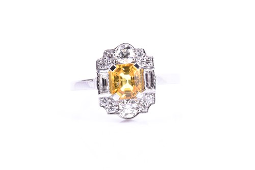 Lot 626 - A platinum, diamond, and yellow sapphire ring,...