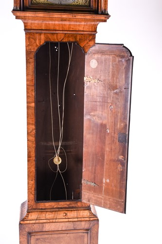 Lot 530 - A Georgian walnut long case clock, the arched...