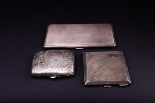 Lot 557 - A group of three silver cigarette cases,...