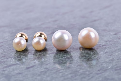 Lot 642 - A pair of reversable pearl and gold stud...