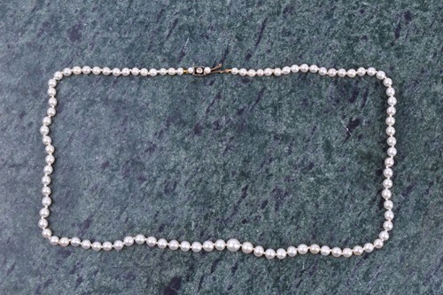 Lot 671 - A cultured pearl necklace, set with graduated...