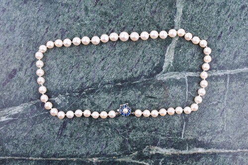 Lot 672 - A cultured pearl necklace, set with white...