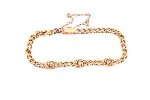 Lot 700 - A yellow gold and diamond bracelet, set with...