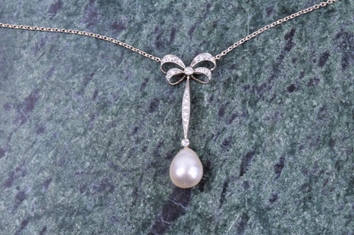 Lot 730 - A diamond and pearl drop pendant necklace, the...