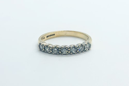 Lot 755 - A 9ct yellow gold and diamond half eternity...