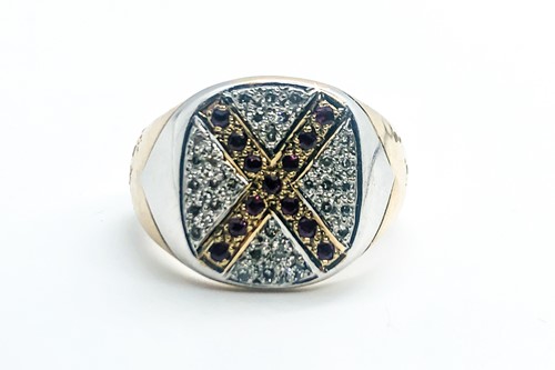 Lot 760 - A 9ct yellow gold, diamond, and ruby ring...