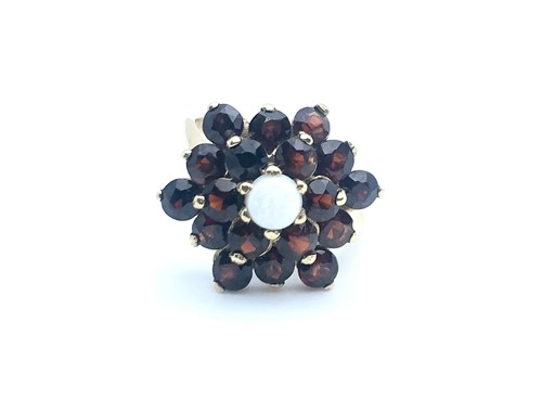 Lot 770 - A 9ct yellow gold, garnet, and opal floral...