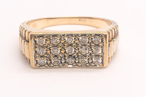Lot 787 - A 9ct yellow gold and CZ gents ring, the...