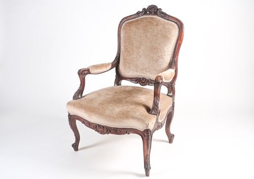 Lot 259 - A French Louis XV style carved walnut fauteuil...