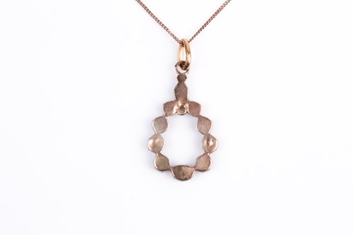 Lot 124 - A silver gilt and diamond pendant, the...