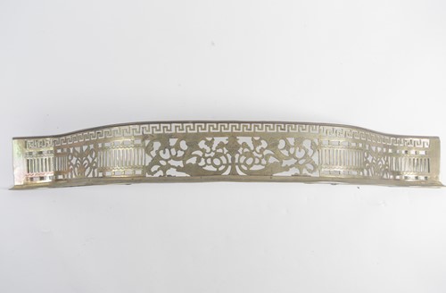 Lot 109 - A George III serpentine brass fender with...