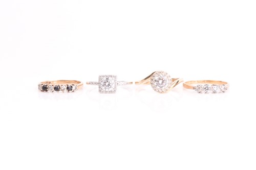 Lot 12 - A four stone half hoop ring, comprising two...