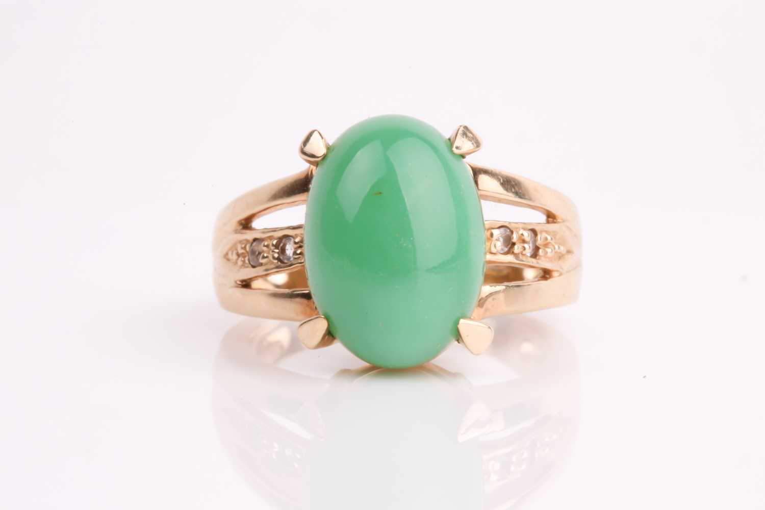Lot 108 - A jade and diamond ring, the oval jade...