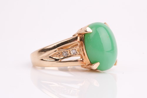 Lot 108 - A jade and diamond ring, the oval jade...