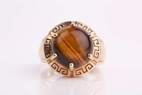 Lot 292 - A single stone tiger's eye dress ring, the...
