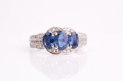 Lot 227 - A sapphire and diamond three stone cluster...
