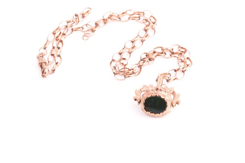 Lot 158 - A three stone swivel fob pendant in 9ct rose...