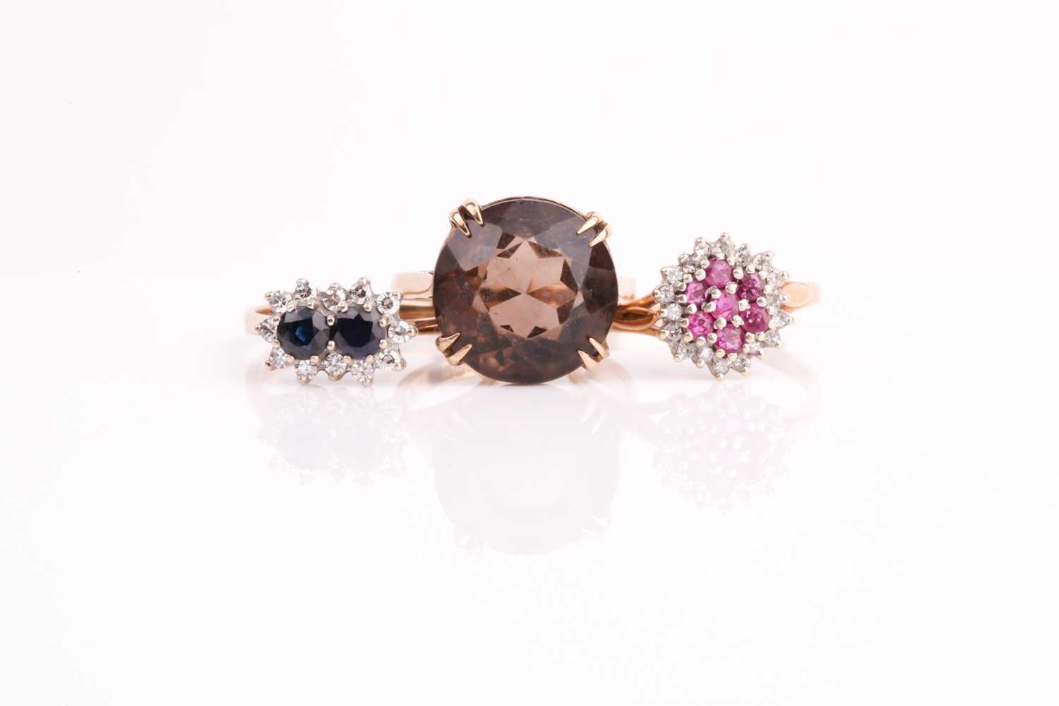 Lot 115 - A ruby and diamond cluster ring, a two stone...