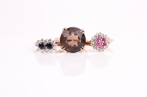 Lot 115 - A ruby and diamond cluster ring, a two stone...