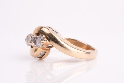 Lot 62 - A three stone diamond crossover ring, the...