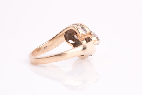 Lot 62 - A three stone diamond crossover ring, the...