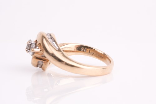 Lot 62 - A three stone diamond crossover ring, the...