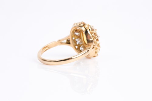 Lot 68 - A yellow sapphire and diamond cluster ring,...