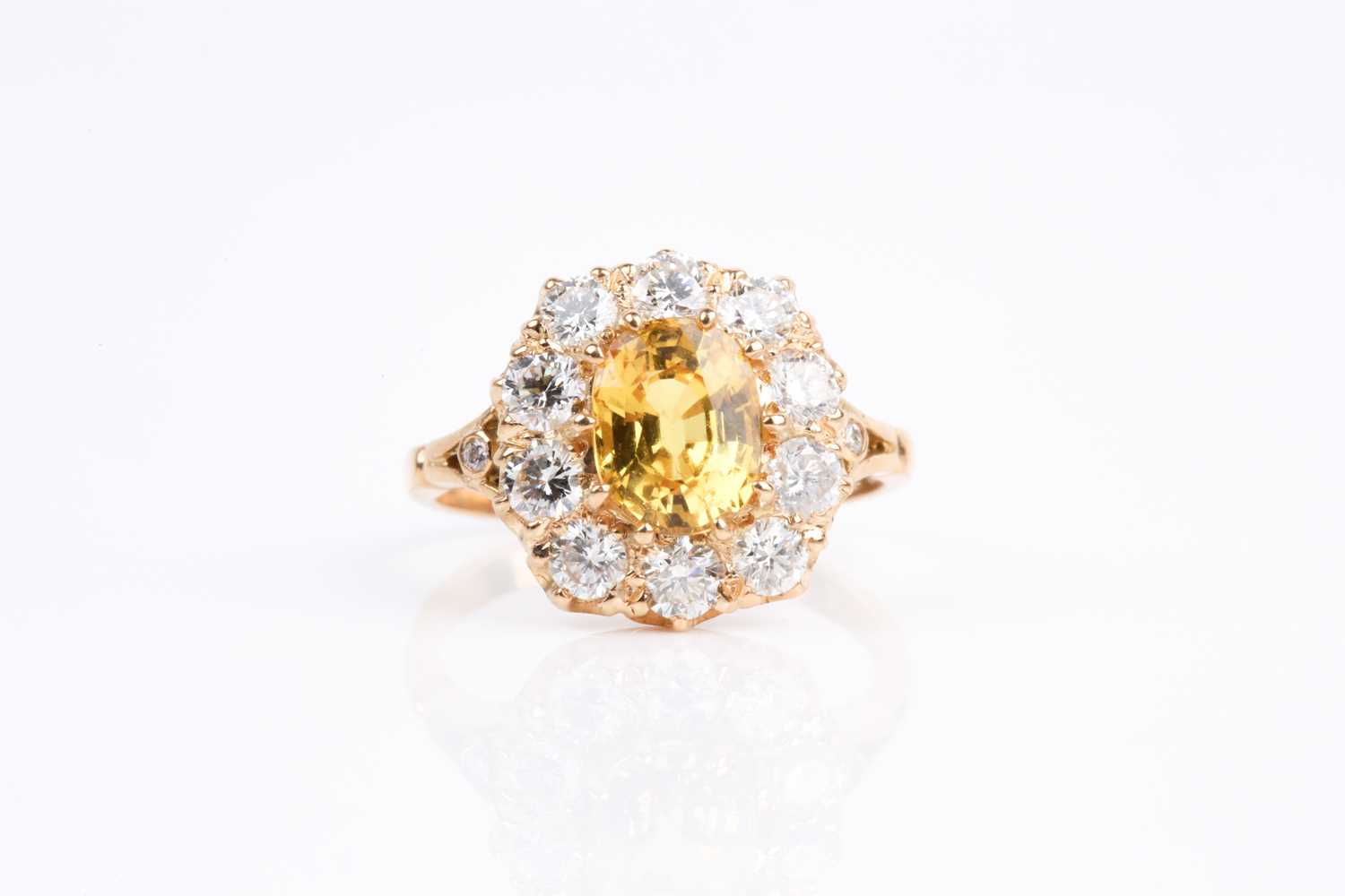 Lot 68 - A yellow sapphire and diamond cluster ring,...