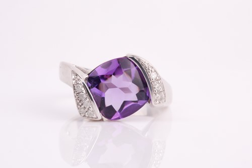 Lot 194 - A 9ct white gold, diamond, and amethyst ring,...