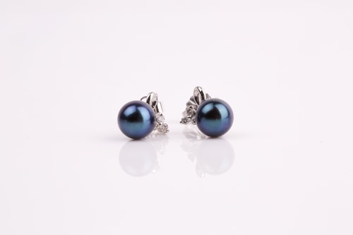 Lot 48 - A pair of 18ct white gold, diamond, and black...
