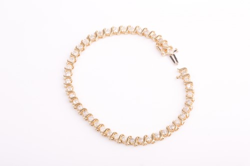 Lot 66 - A yellow gold and diamond bracelet, set with...