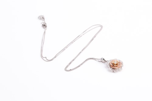 Lot 69 - A two colour 18ct gold and diamond flower head...