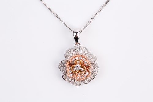 Lot 69 - A two colour 18ct gold and diamond flower head...
