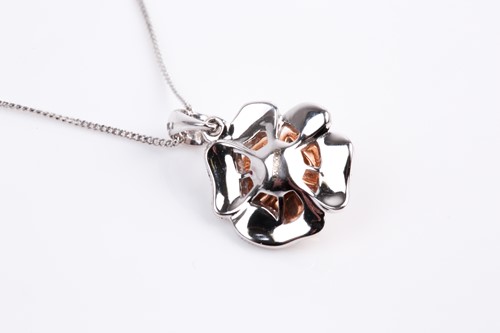 Lot 69 - A two colour 18ct gold and diamond flower head...