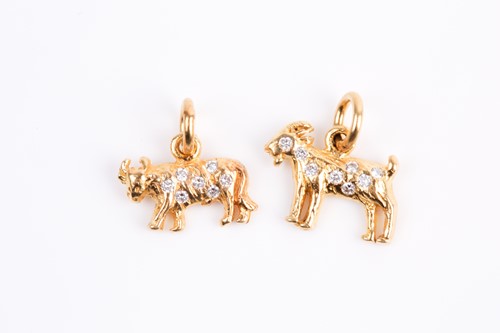Lot 21 - Two diamond set Zodiac charms, the cast Taurus...
