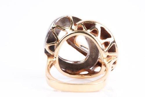 Lot 85 - A white and yellow metal ring, of stylised...