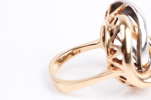 Lot 85 - A white and yellow metal ring, of stylised...
