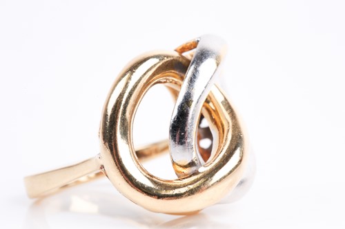 Lot 85 - A white and yellow metal ring, of stylised...