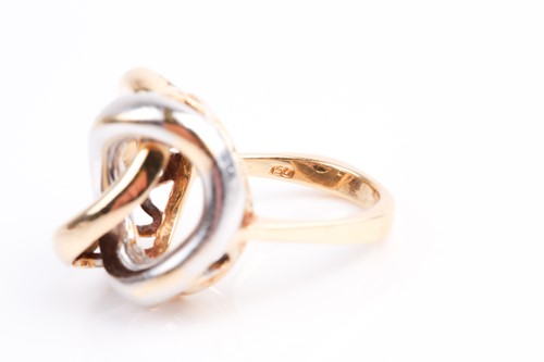 Lot 85 - A white and yellow metal ring, of stylised...