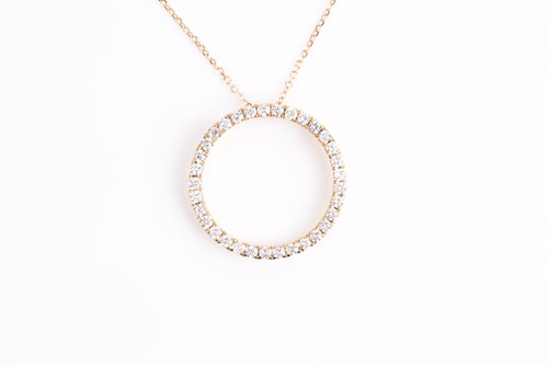 Lot 169 - An 18ct yellow gold and diamond halo pendant,...