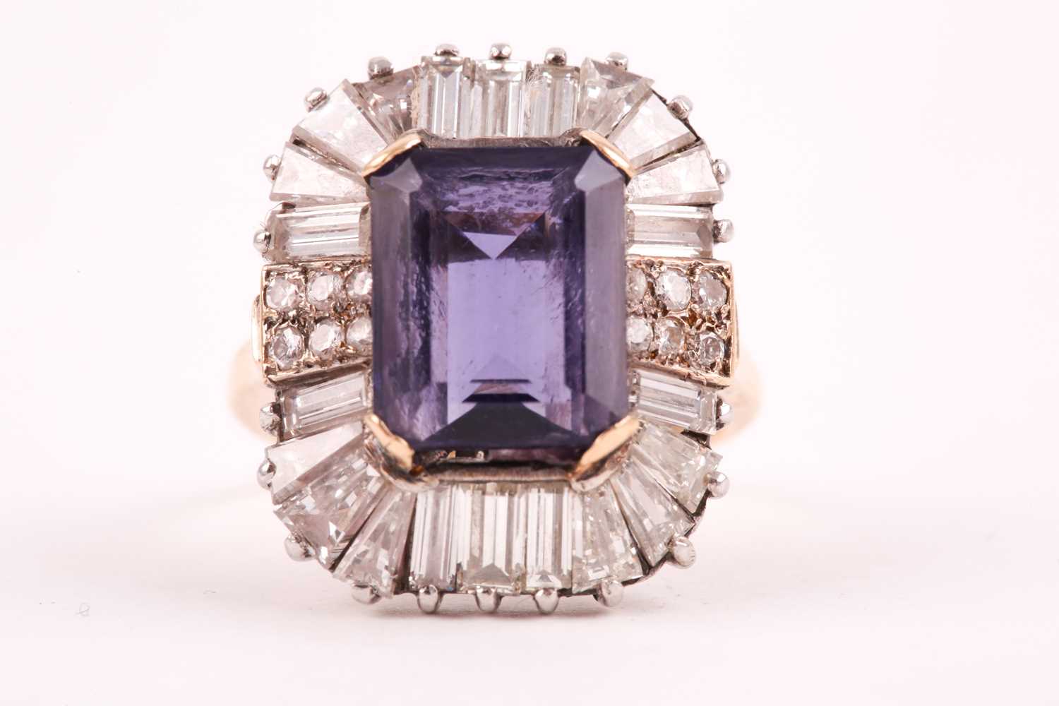 Lot 119 - A diamond and iolite dress ring, the step cut,...
