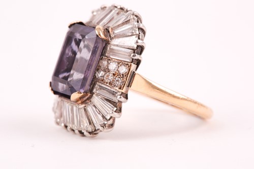 Lot 119 - A diamond and iolite dress ring, the step cut,...