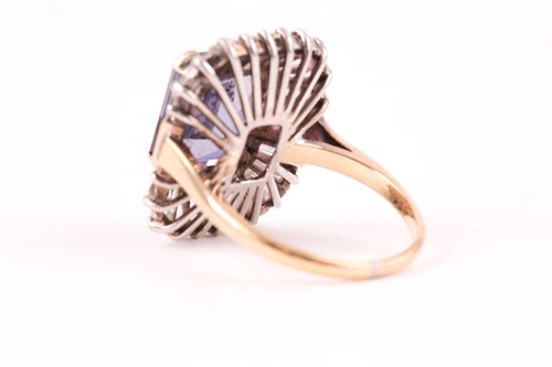 Lot 119 - A diamond and iolite dress ring, the step cut,...