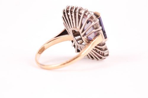 Lot 119 - A diamond and iolite dress ring, the step cut,...